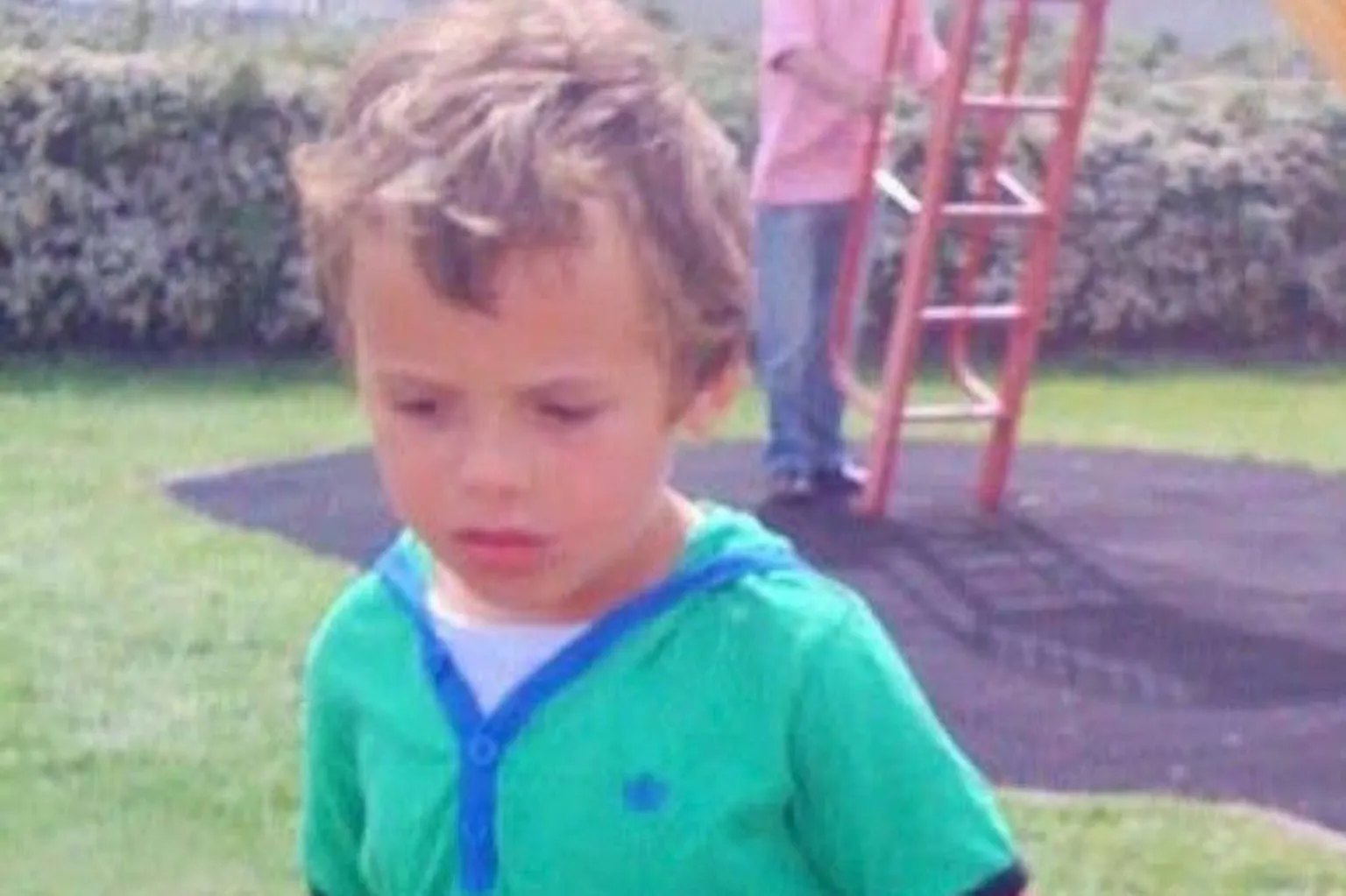 Levi Lewis A young boy in a green top in a playground
