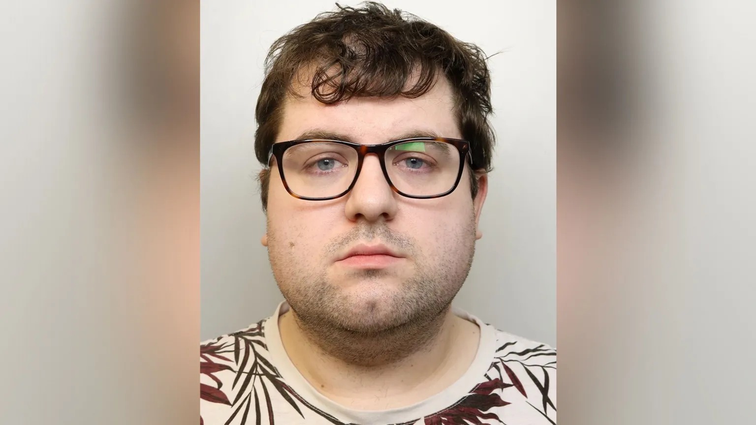 Photo of Bennett wearing glasses against a plain light background.