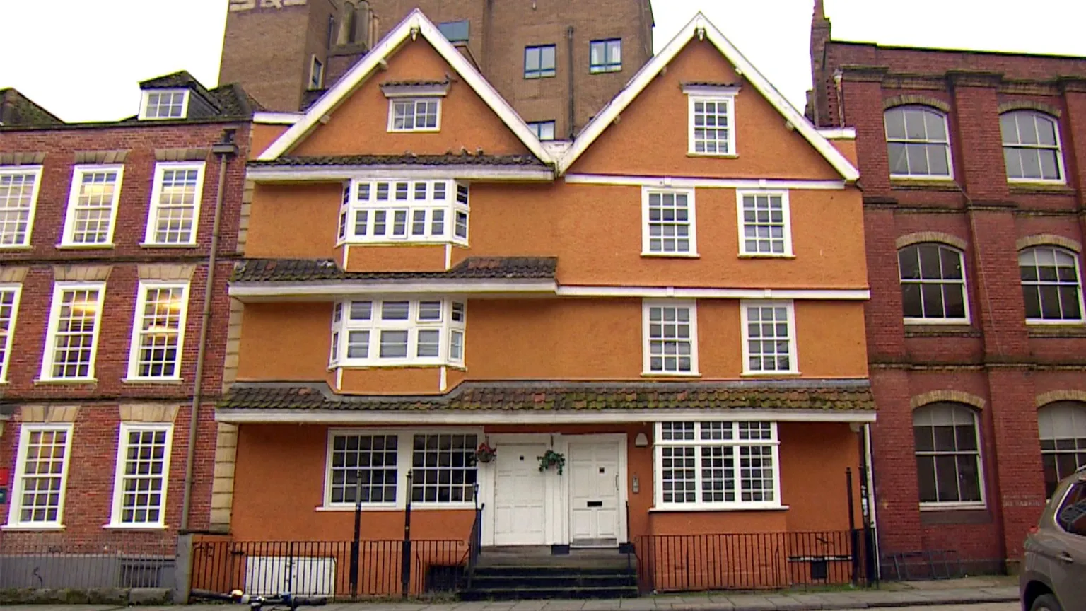 Partou King Street nursery a painted townhouse with white-framed windows, flanked by red-brick buildings on a city street.