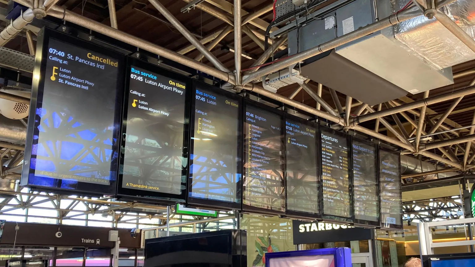Alex Pope/BBC Electronic boards show cancelled services at Bedford Railway Station.