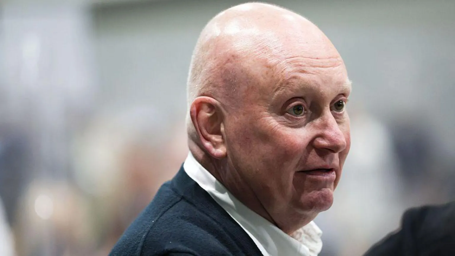 Kevin Lee, a bald middle aged man in open neck shirt, looks on at the Makerfield by-election count