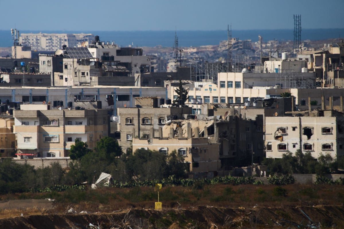 buildings with the sea in the background and a single yellow block in the foreground