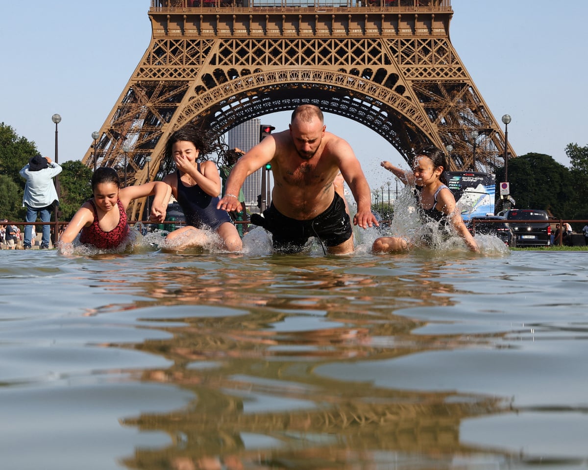 People cool off in the Trocadero Fountain next to the Eiffel Tower in Pari