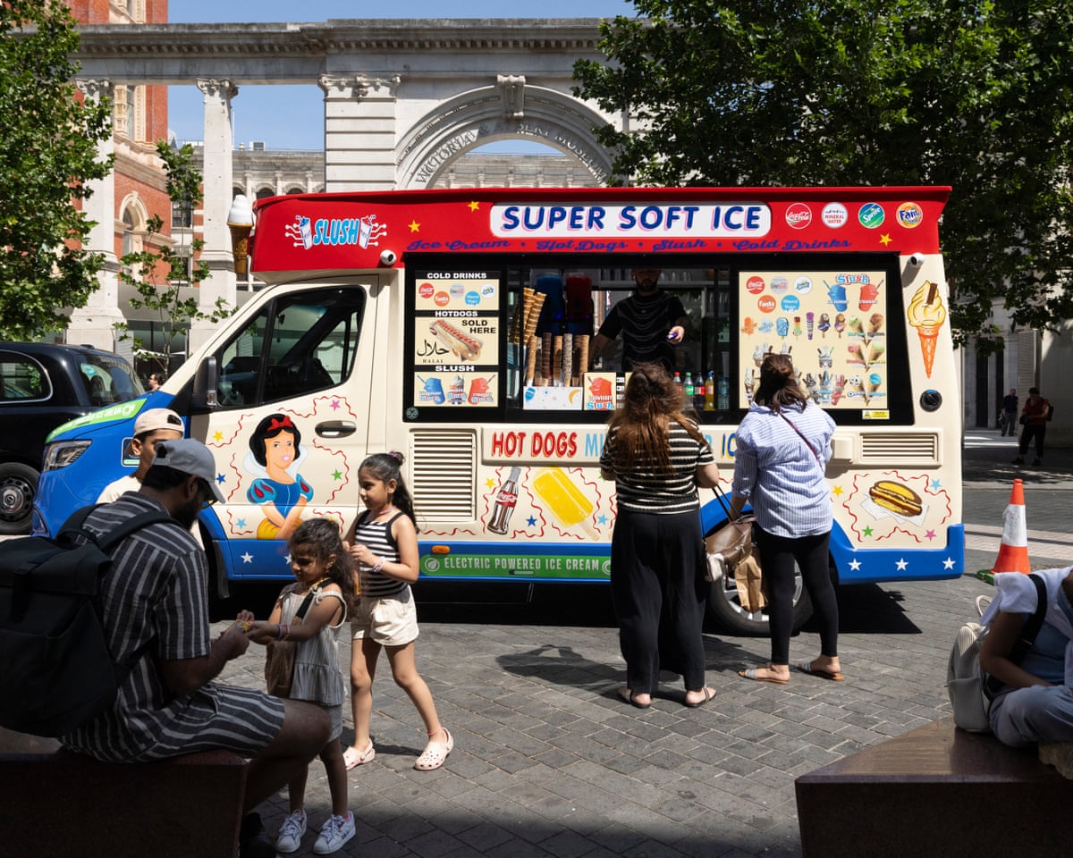 People buy ice creams from a van in South Kennsington, London