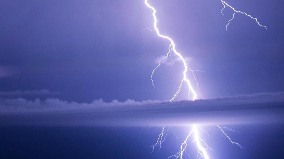 Lightning strike across a dark sky. 