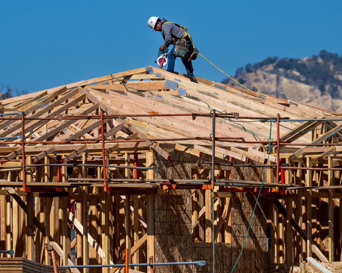A worker on the roof of a new home under construction.