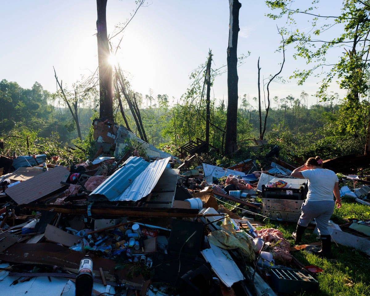 A woman searches for belongings after a tornado in Indiana.