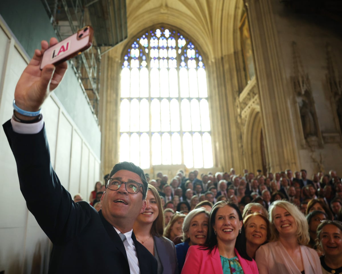 Andy Burnham takes a selfie with Labour party MPs at the Houses of Parliament in London.