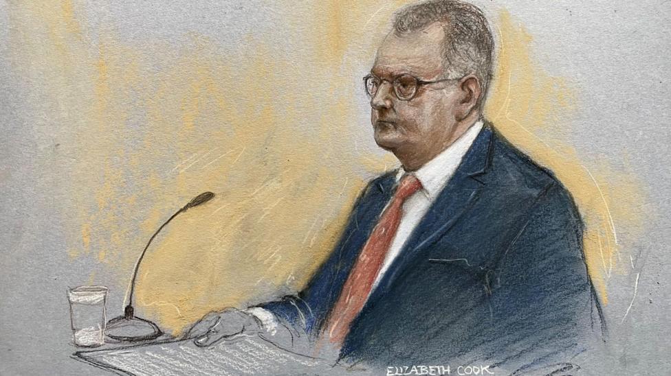 A court sketch of Jeffrey Donaldson at his trial wearing a suit and red tie.