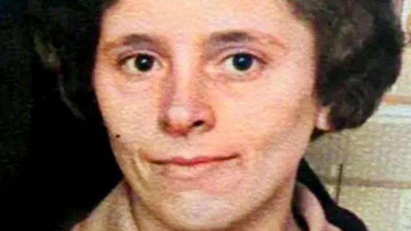 A photo of Kathleen. She has brown eyes and short brown hair. She is doing a small smile at the camera with her mouth closed.