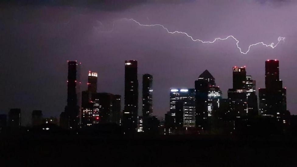 Lightning flashes above the London skyline.