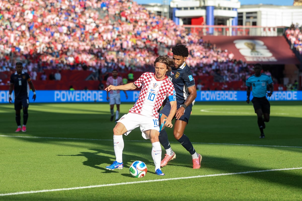 Croatia captain Luka Modric is challenged by Carlos Harvey of Panama.