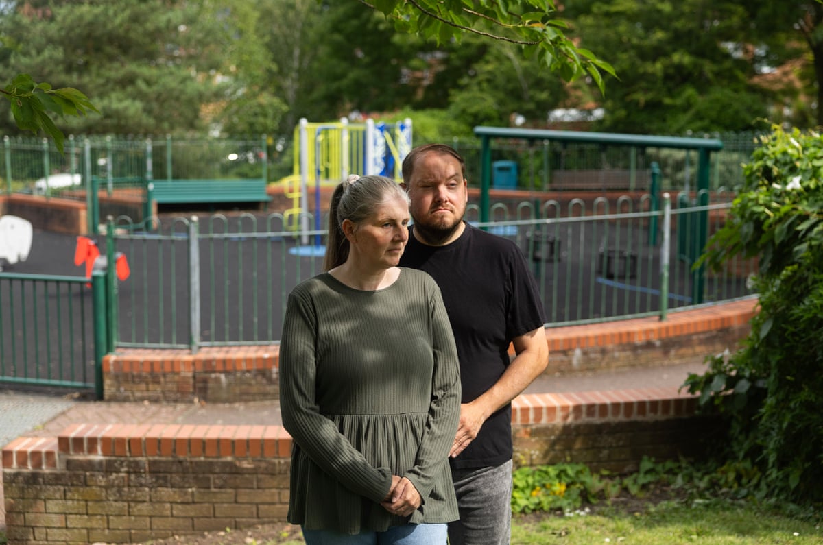 Sarah and Gary Andrews stood in a playground.
