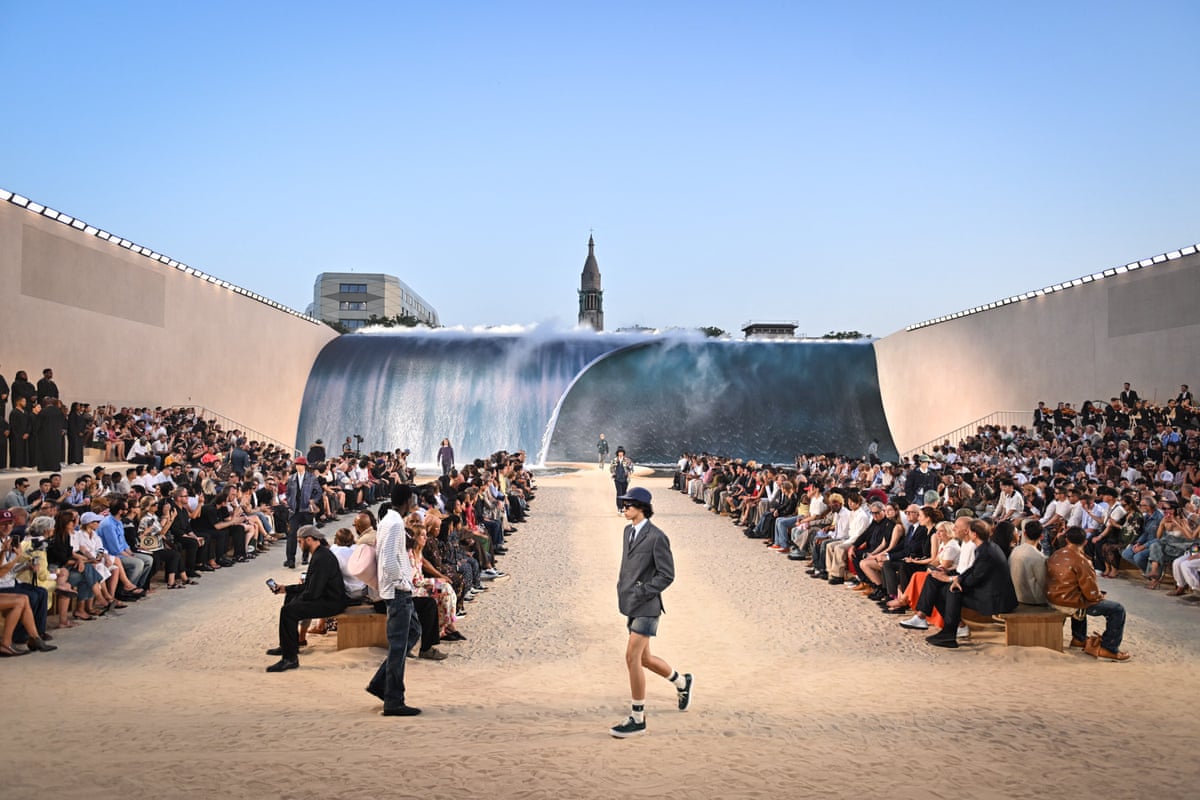Catwalk covered in sand in centre of Paris outside with wave backdrop