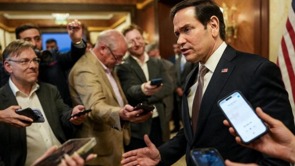 Marco Rubio surrounded by reporters in Kuwait