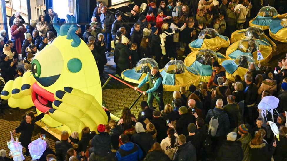 A parade follows a space themed carnival