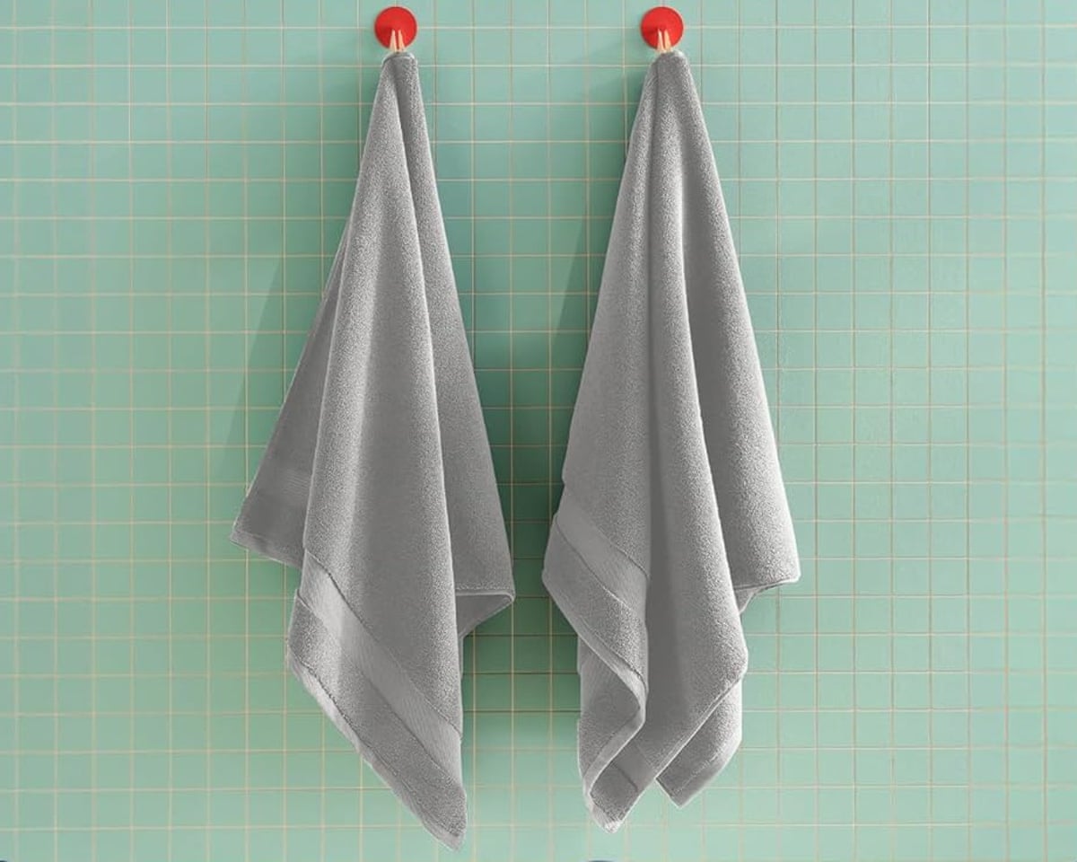 two gray towels hanging on hooks