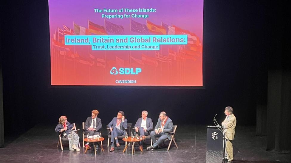 Baroness Sue Gray sitting on a panel on a stage with a screen saying 'The future of these islands: Preparing for change. Ireland Britain and Global relations: Trust, leadership and change