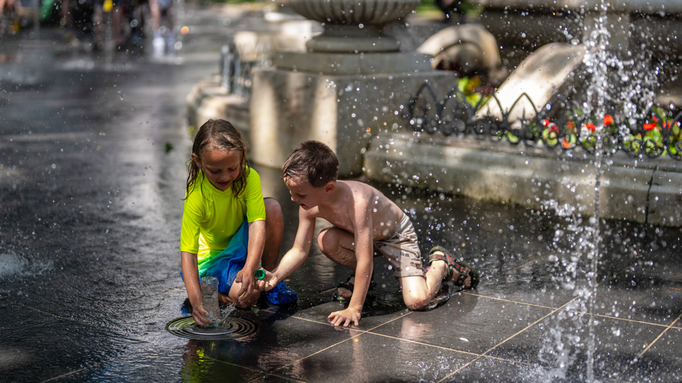 LONDON, ENGLAND - JUNE 23: Children play in a fountain in Leicester Square on June 23, 2026 in London, England. 