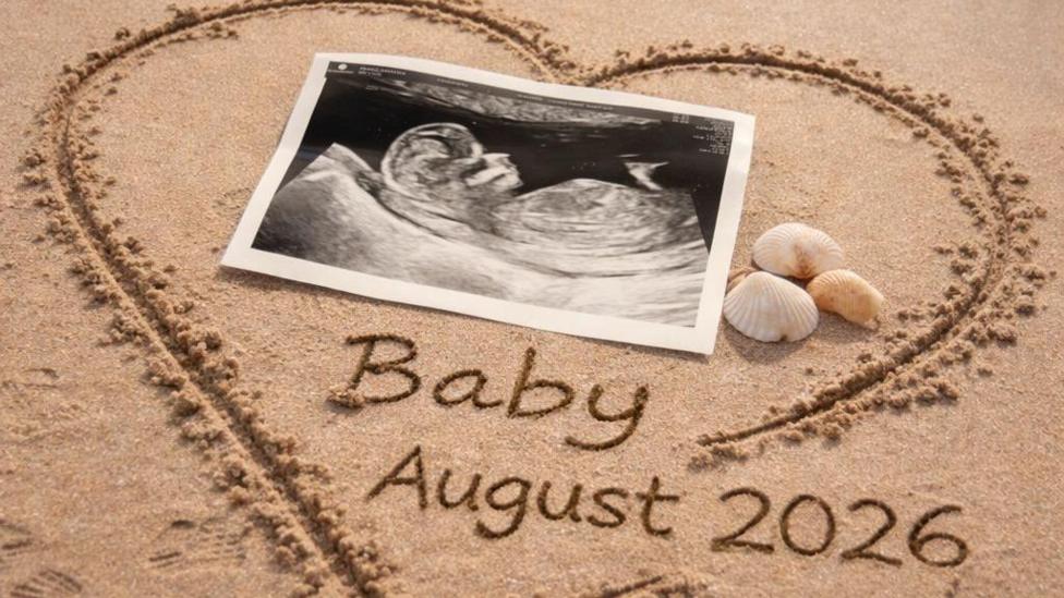 A heart shape has been drawn in sand and 