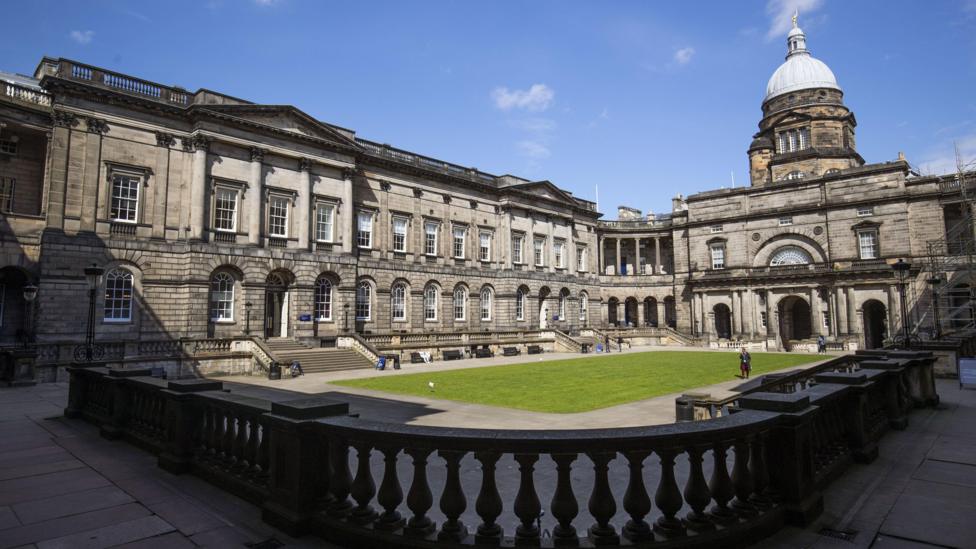 An exterior view of the University of Edinburgh's Old College building on a sunny day. 