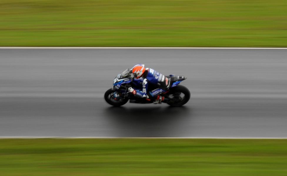 A superbike racer on a racing track.