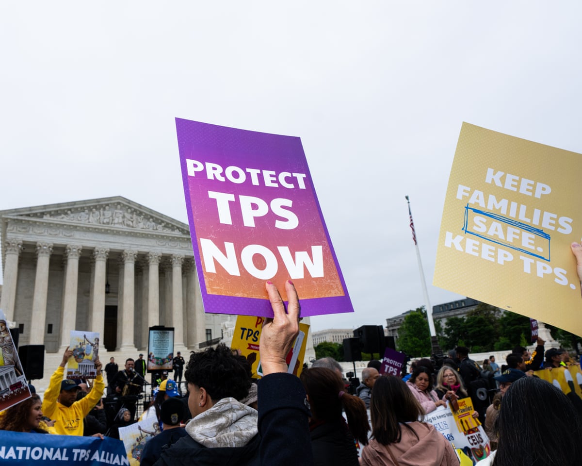 People hold signs saying ‘protect TPS now’ outside supreme court building