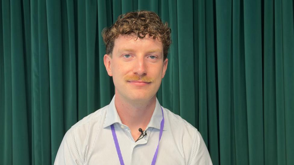 Tom Cantillon sat in an office looking at the camera