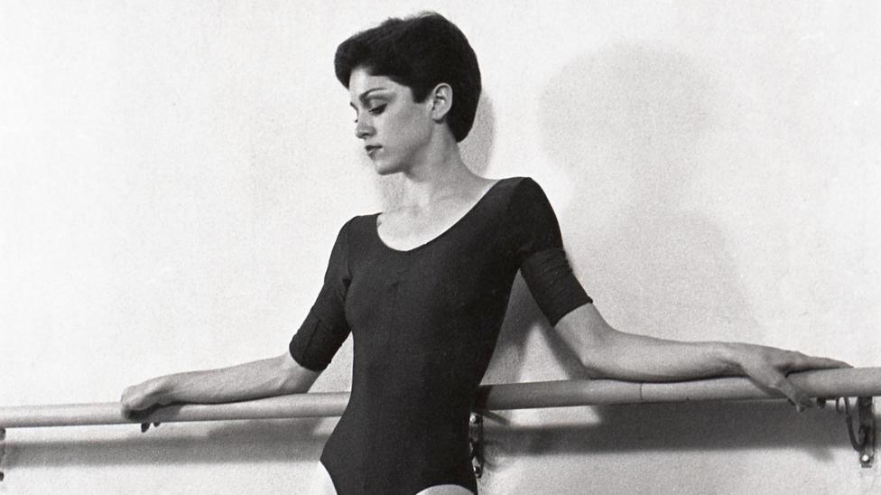 Madonna poses against a ballet barre during an early photoshoot in 1977