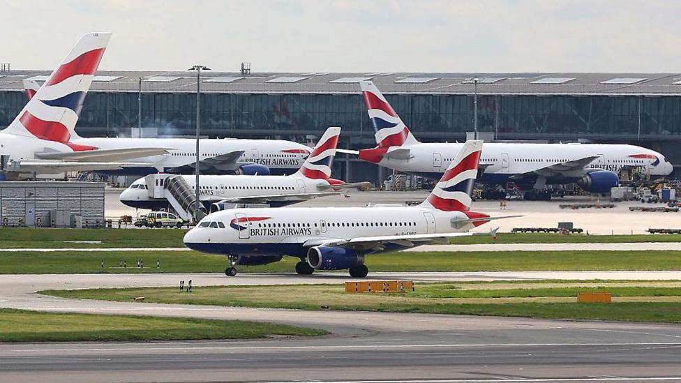 A British Airways Airbus A319 taxis near to Heathrow Airport's Terminal 5.
