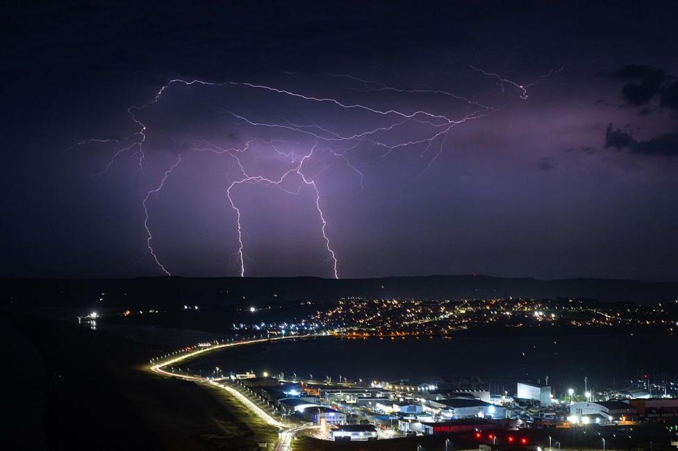Lightning strikes are seen during a storm over Weymouth.
