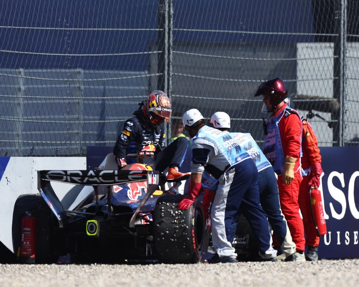 Marshals assist Max Verstappen after crashing his Red Bull