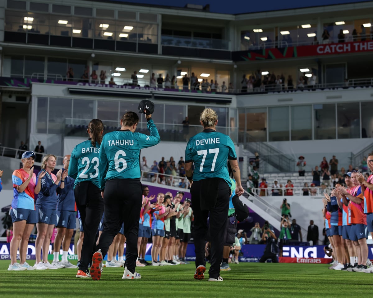 Suzie Bates, Sophie Devine and Lea Tahuhu of New Zealand receive a guard of honour as they leave the playing field on their retirement from T20 International cricket.