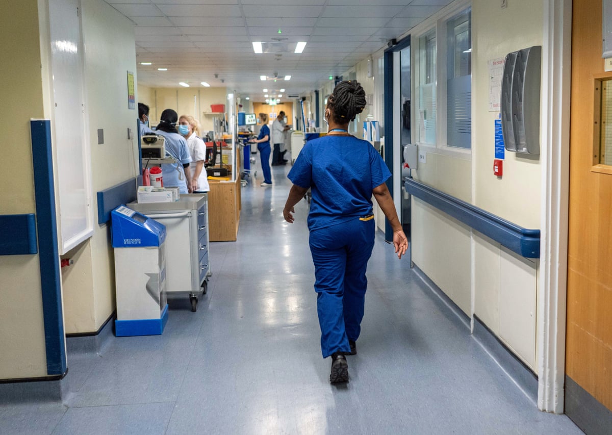 NHS staff walking in a hospital corridor