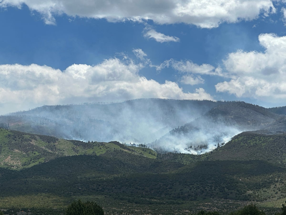 smoke rises in distance