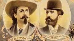 A section of a 1895 poster promoting 'Buffalo Bill's Wild West' tour of California. Cody to the left has long hair, a dark handlebar moustache with chin beard and a Stetson hat. Salsbury on the right has a brown beard and is less flamboyantly dressed in a suit and bowler hat.