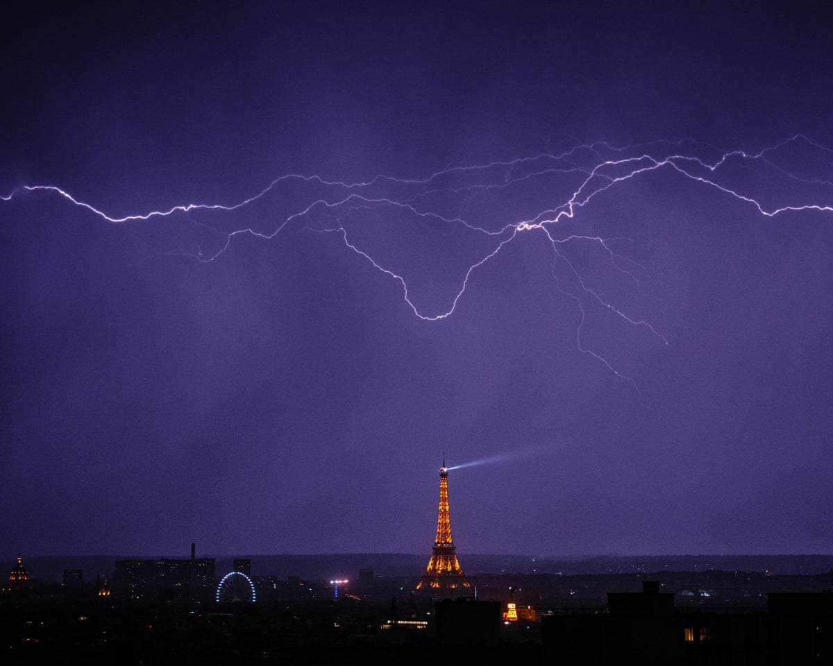 Lightning strikes over the Eiffel Tower during a thunderstorm in Paris, London.