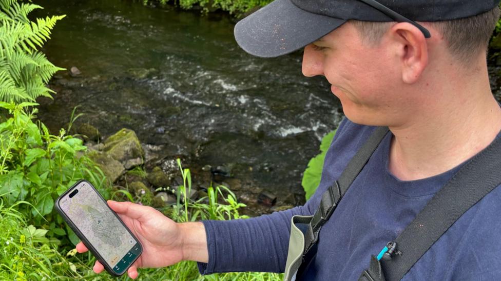 Marcus Bowles demonstrating the app for recording species of fish
