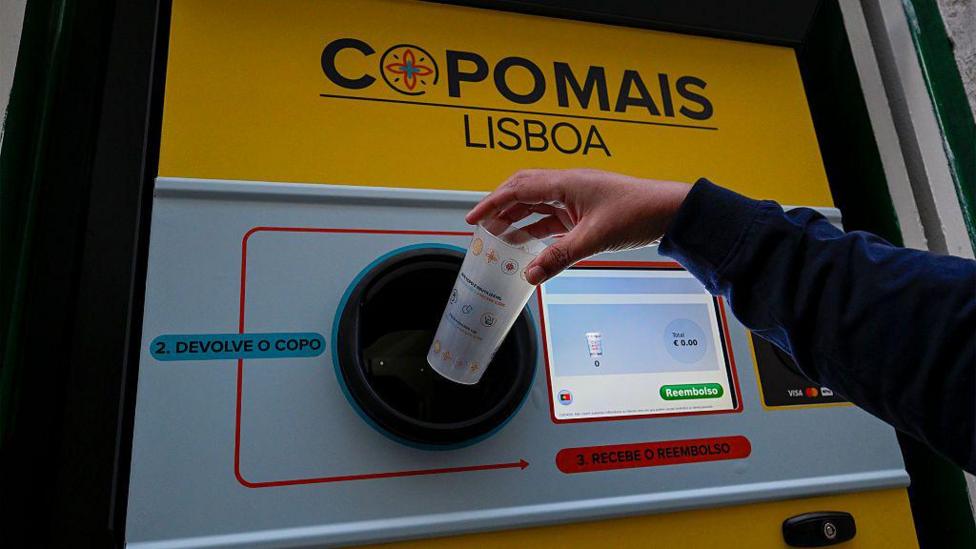 A reverse vending machine for plastic cups in Portugal. It has a computer screen which shows the total amount a person is being reimbursed