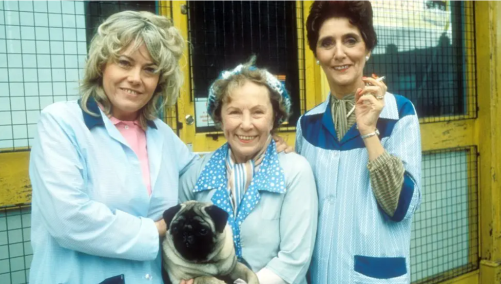 Pauline, Ethel and Dot Cotton with dog Willy outside the launderette in Eastenders