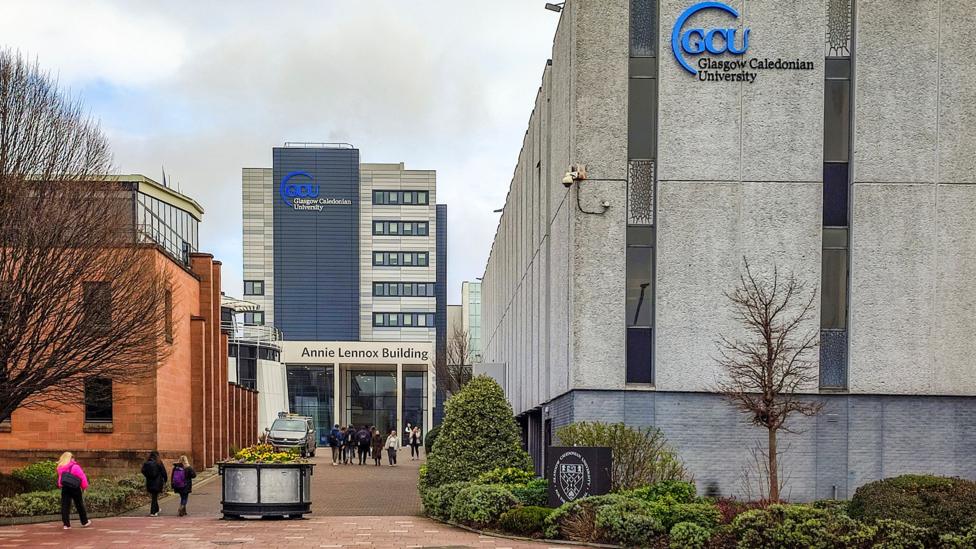 A university with grey buildings and GCU written on the side of some of them