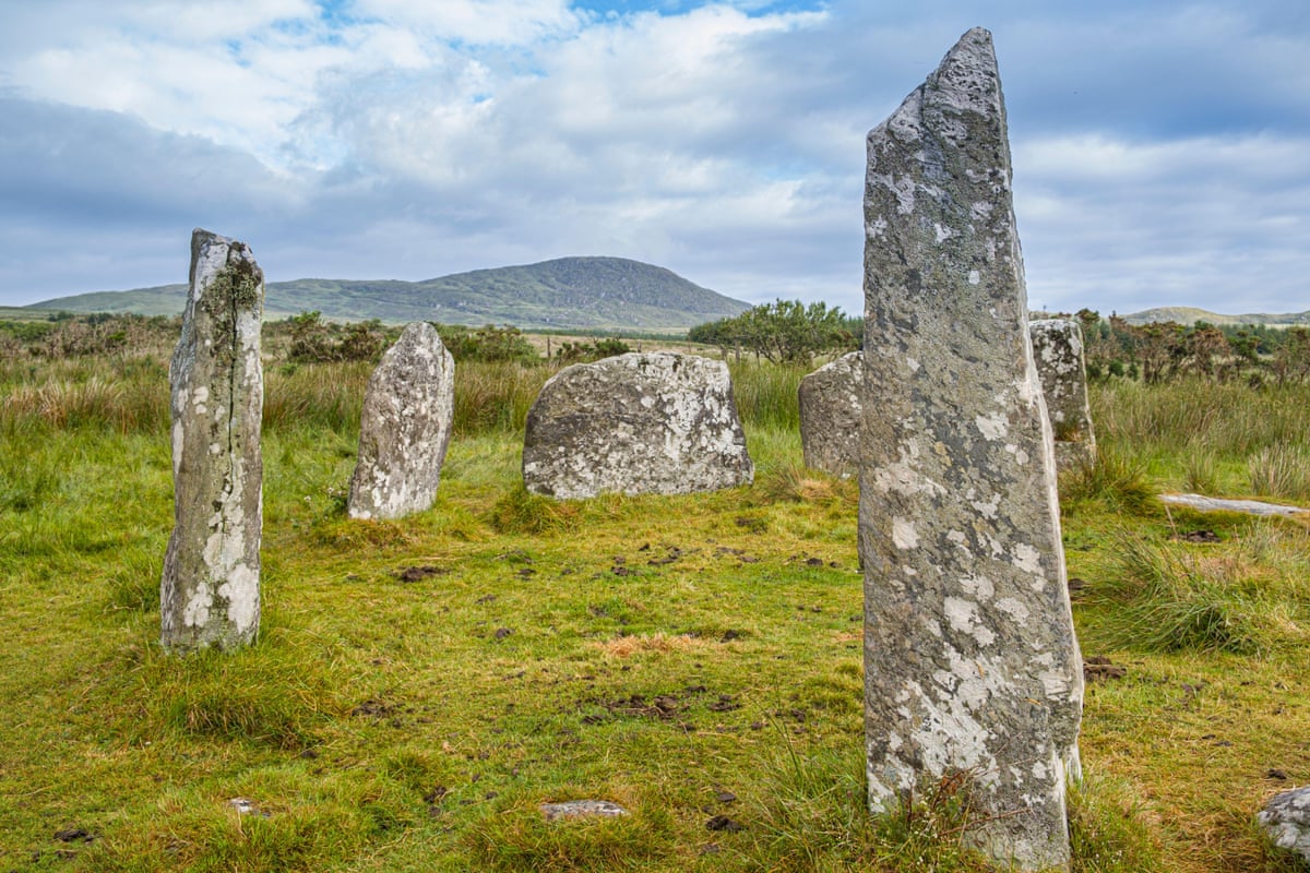 Upright old stones in a grassy landscape
