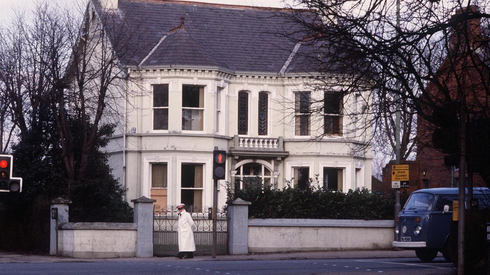 A large house in front of a street.