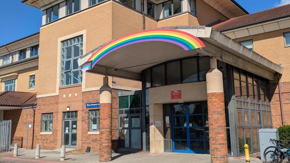 A rainbow over the entrance to a hospital site