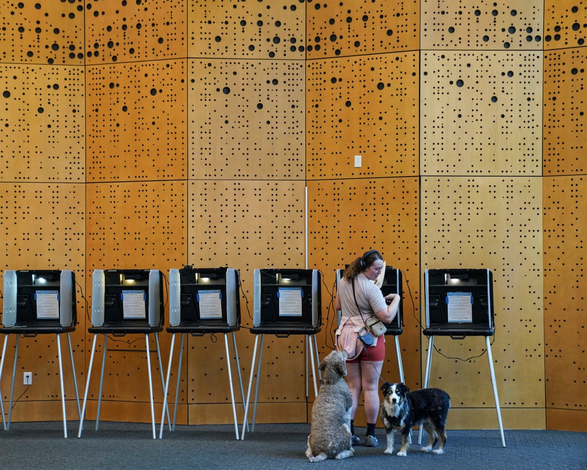 Danielle Grisolano brings her dogs, Lincoln and Pepper, with her to vote in the Democratic primaries at Denver Public Library on 30 June 2026.