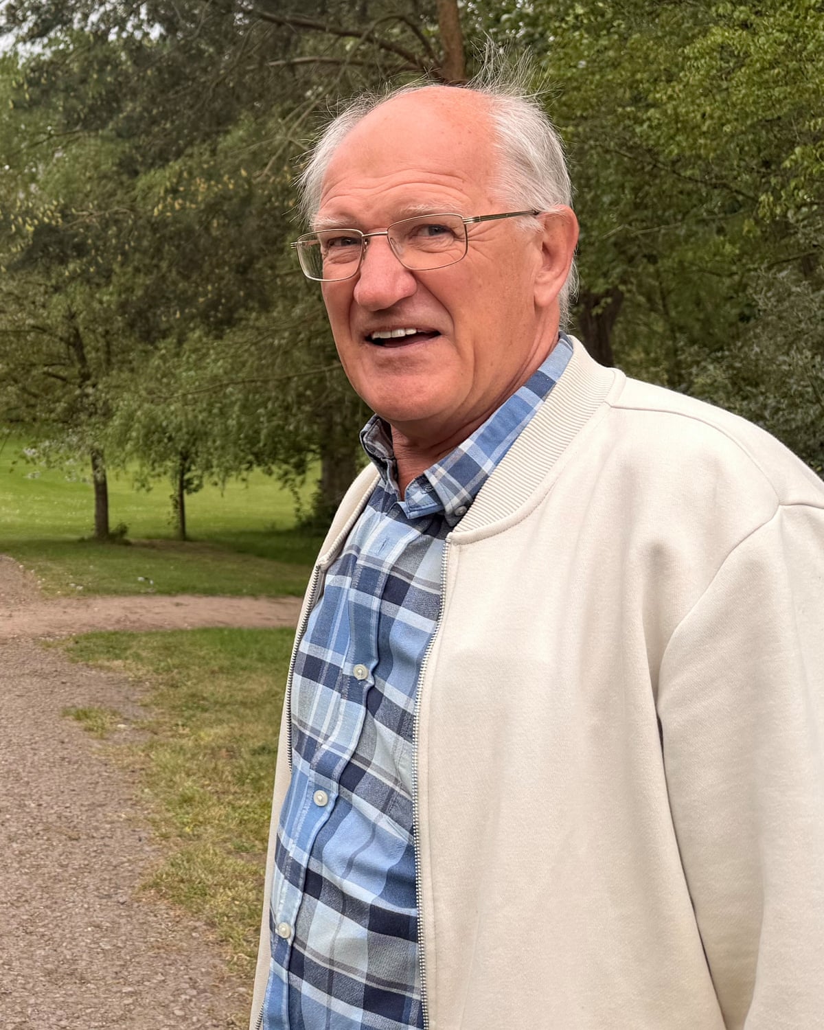 Graham Warner standing in front of trees looking at the camera
