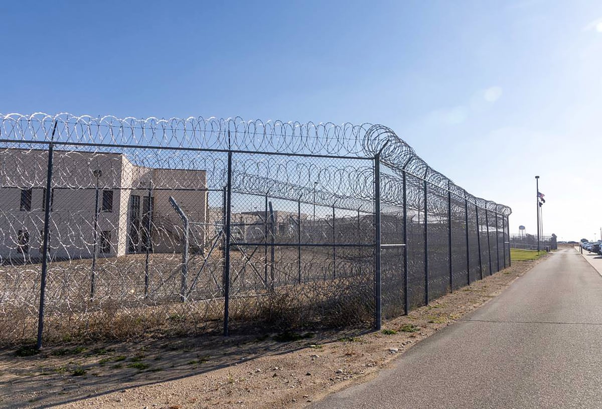 a barbed wire fence surrounds a prison
