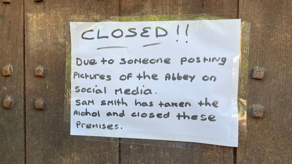 A photo of a sign stuck outside the Abbey pub in Darley Abbey, reading: