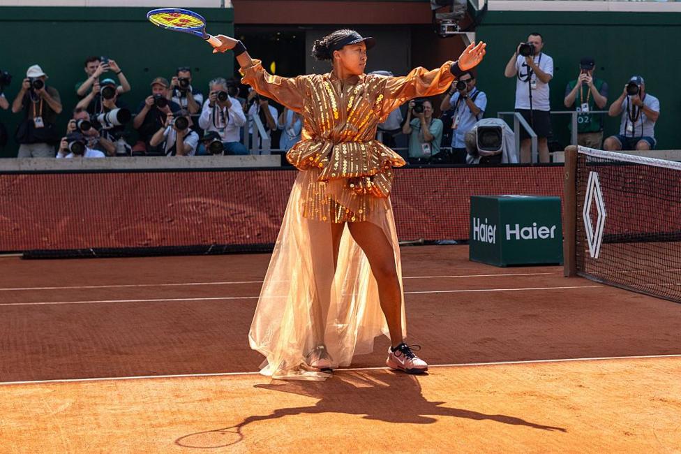 Naomi Osaka wearing a shimmering golden dress at the French Open