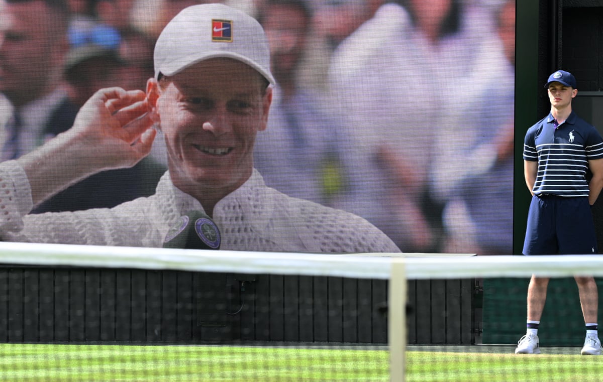 Italy’s Jannik Sinner image is seen on a large courtside screen
